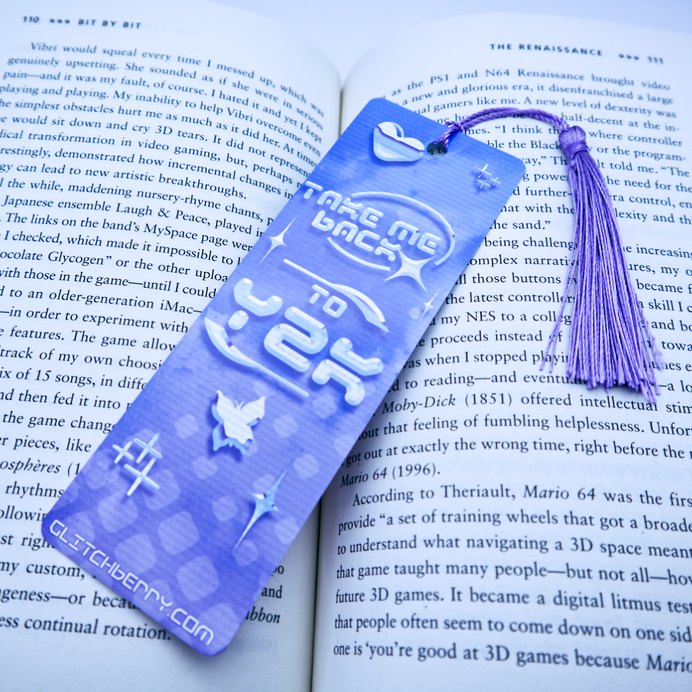 Blue bookmark with with the text "Take me back ty Y2k" and a tassel on an open book