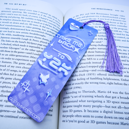Blue bookmark with with the text "Take me back ty Y2k" and a tassel on an open book