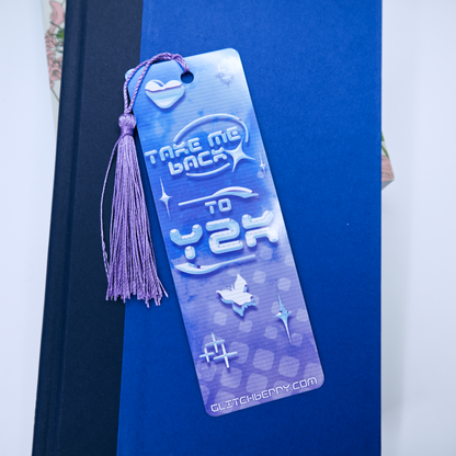 Blue bookmark with the text "Take me back ty Y2k" and a tassel on a blue background