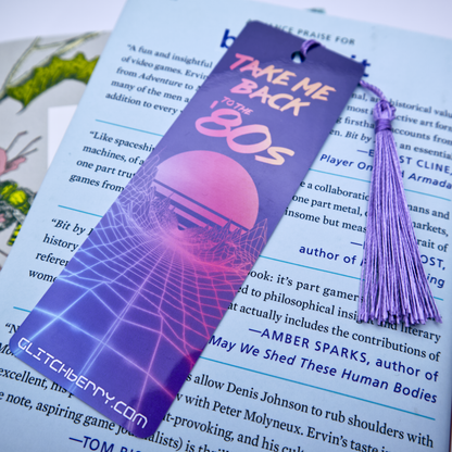 Purple 'Take Me Back to the 80s' bookmark with tassel on a book page.