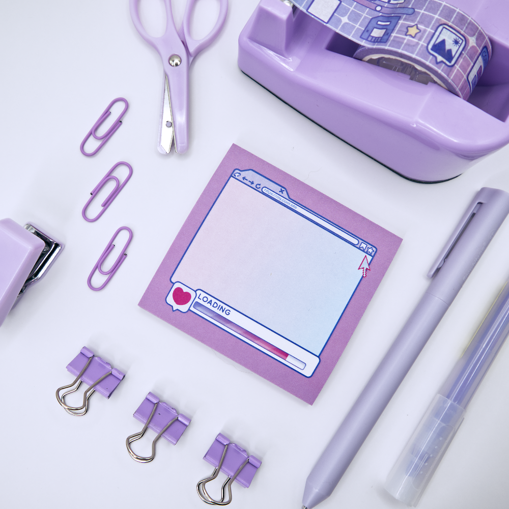 Pink sticky note pad with an internet browser loading screen design on a white background surrounded by stationery items.