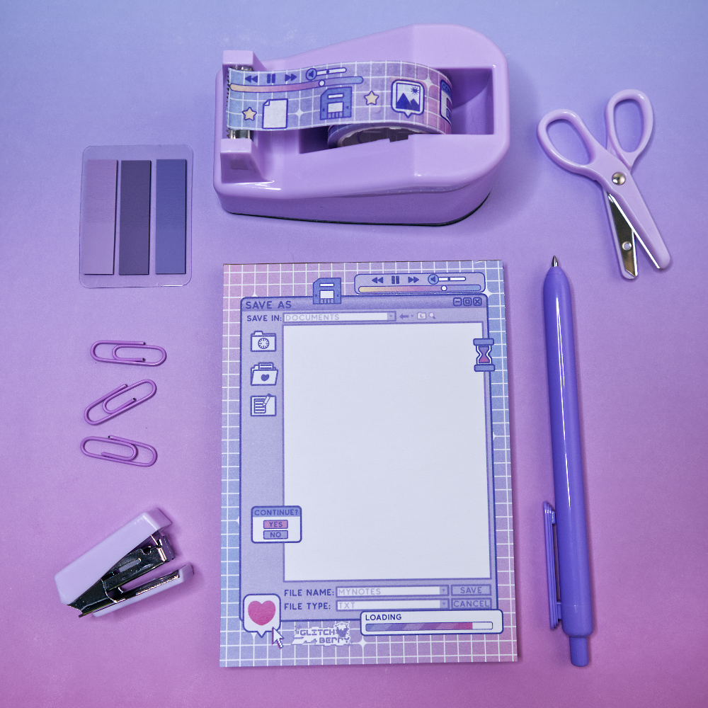 Purple stationery items including a celestial computer-themed notepad, washi tape, plus scissors and a pen on a purple background.