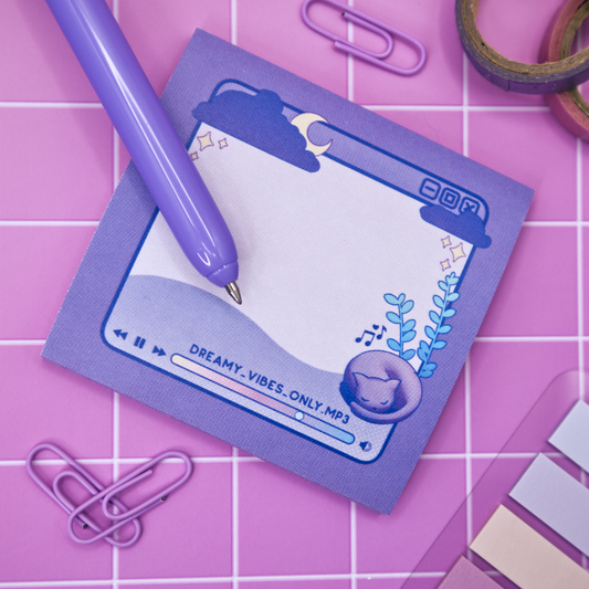 Purple sticky note pad with music player design featuring a cat and a plant on a pink grid background
