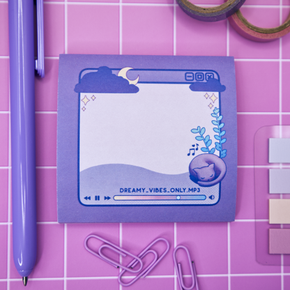 Purple sticky note pad with music player design featuring a cat and a plant on a pink grid background