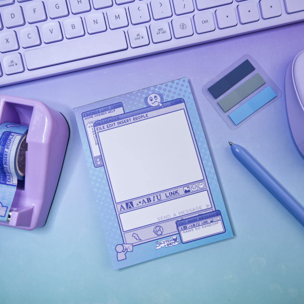 Notepad with instant messenger themed design on a desk with keyboard and stationery items
