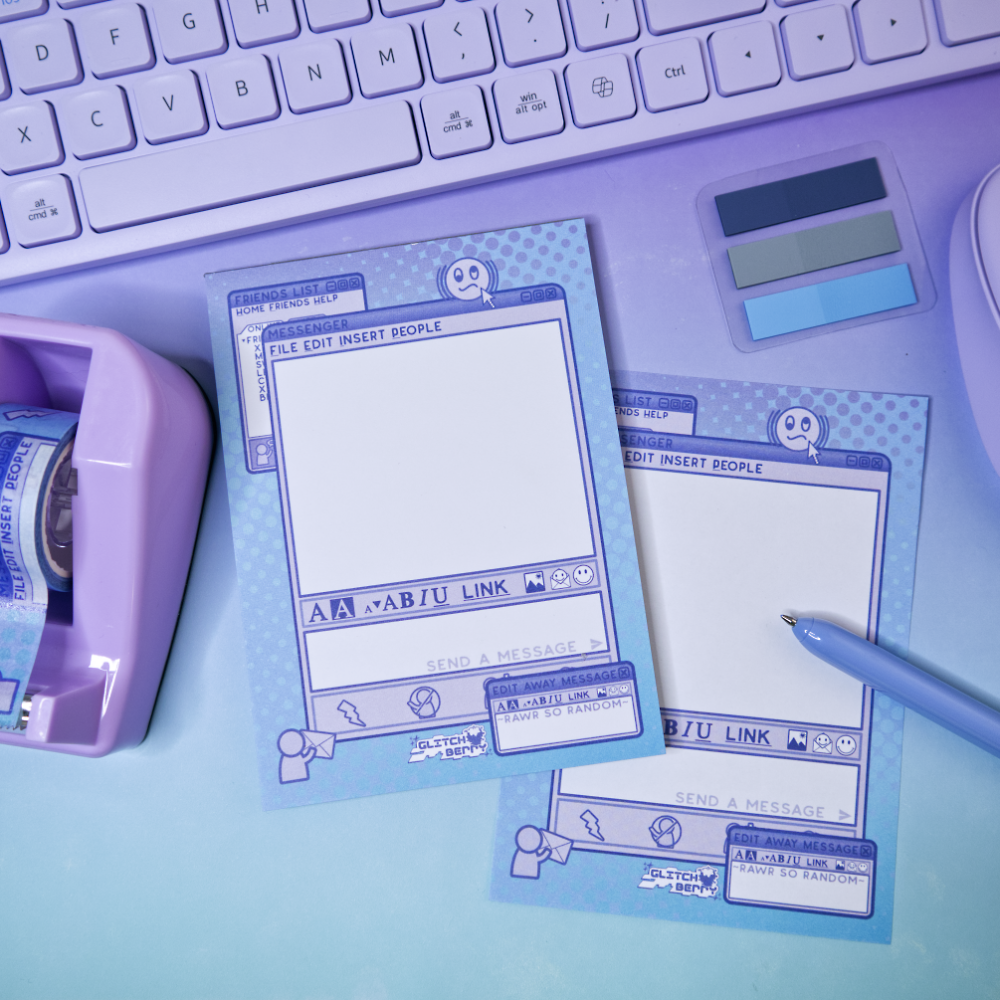 Two blue instant messenger themed notepads with a pen on a light purple surface, next to a keyboard.