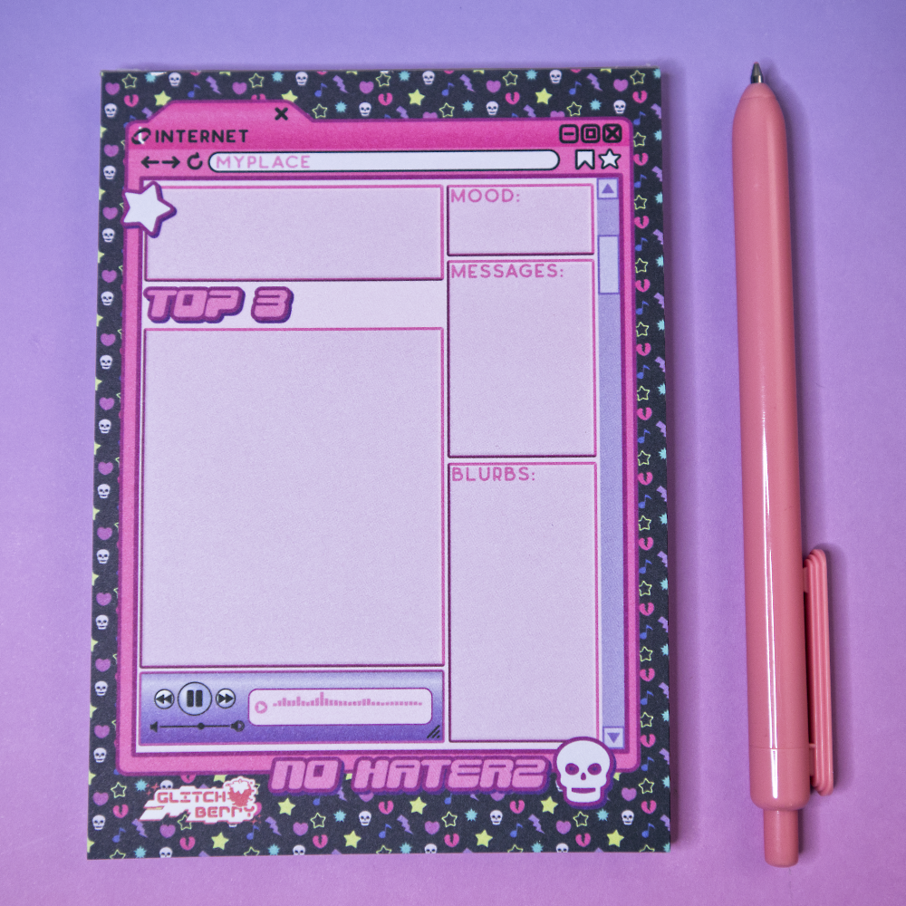 Notepad with pink emo-themed design and a pink pen on a purple background