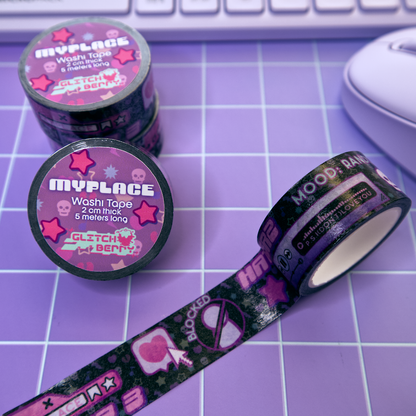 Rolls of black emo-theme patterned washi tape with decorative designs reminiscent of early social profile pages on a purple grid surface with a keyboard in the background.