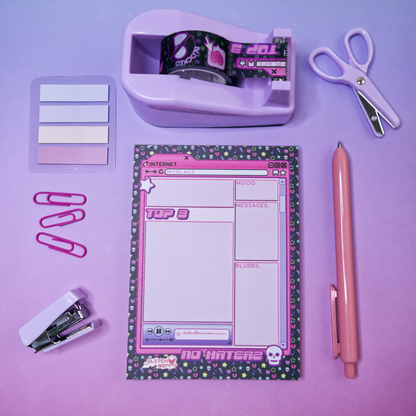 Stationery items including a pink emo-themed notepad and washi tape, a pen, and scissors on a purple background.