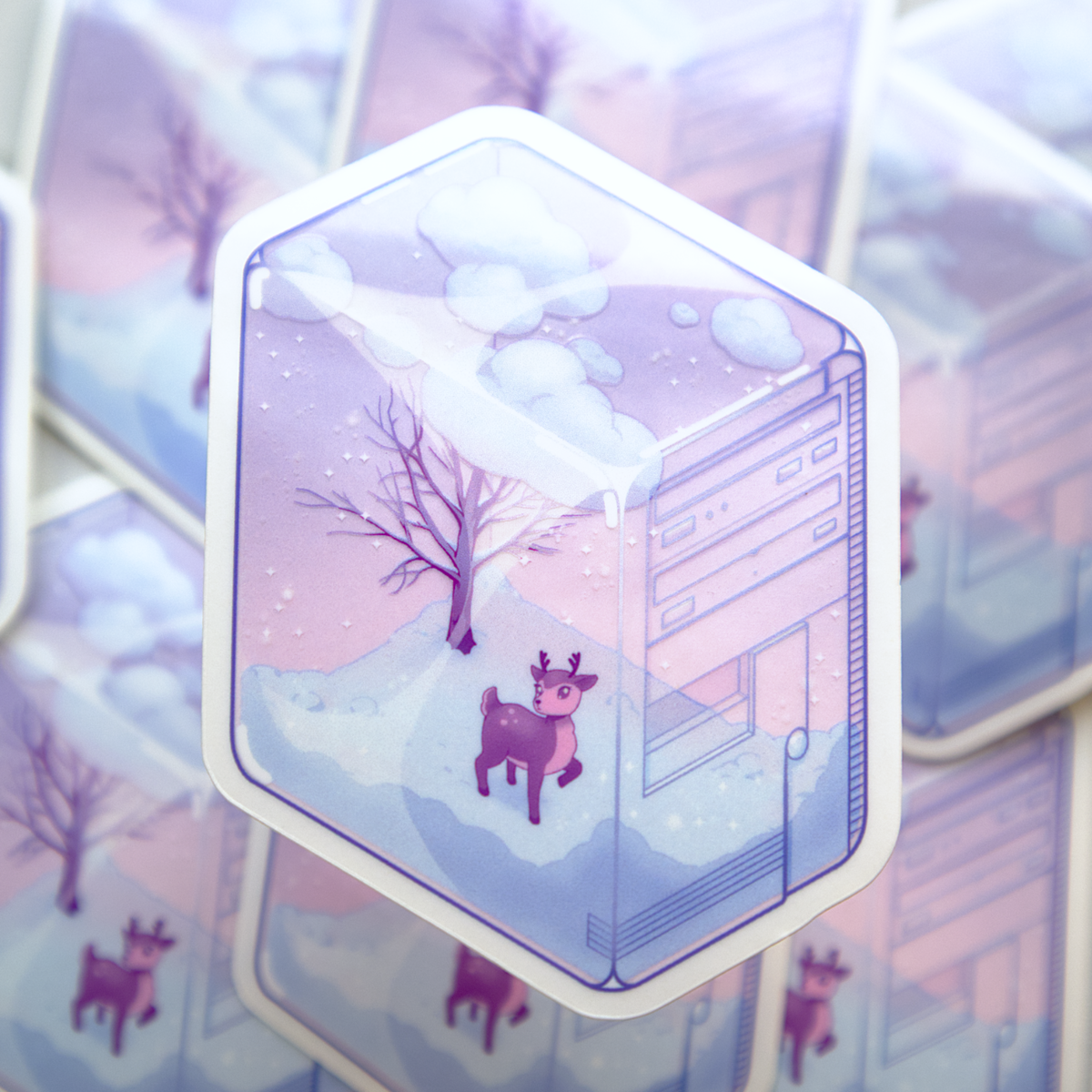 A die-cut sticker featuring a winter scene with a small deer, bare tree, and snow, inside of a translucent PC tower like a snow globe.  Sticker is photographed on a background of a stack of the same sticker.