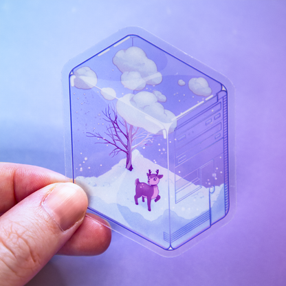 A hand holds a die-cut sticker featuring a winter scene with a small deer, bare tree, and snow, inside of a translucent PC tower like a snow globe.  Sticker is photographed on a purple background.