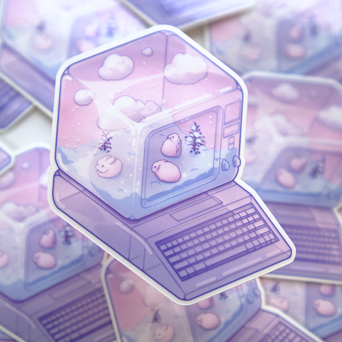A die-cut sticker featuring a winter scene with small rabbits, bare shrubs, and snow, inside of a translucent PC tower like a snow globe.  Sticker is photographed on a background of a stack of the same sticker.