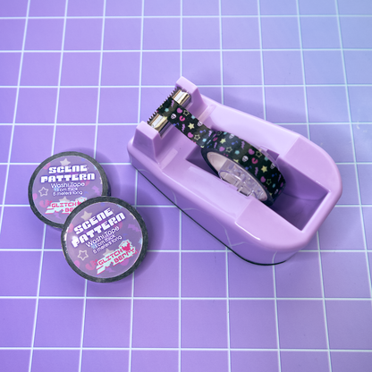 Purple tape dispenser with emo-theme patterned tape on a purple grid background