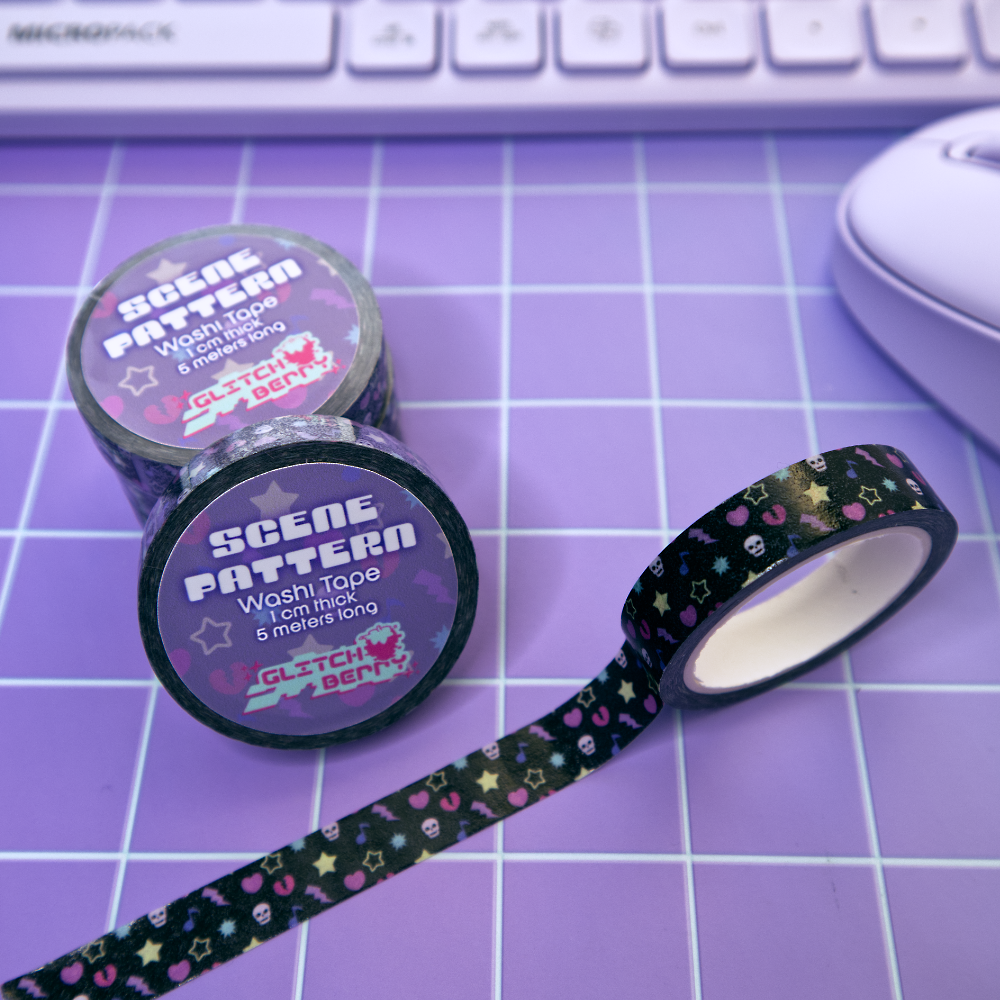 Two rolls of 'Scene Pattern' wash tape with a strip of tape on a purple grid background.